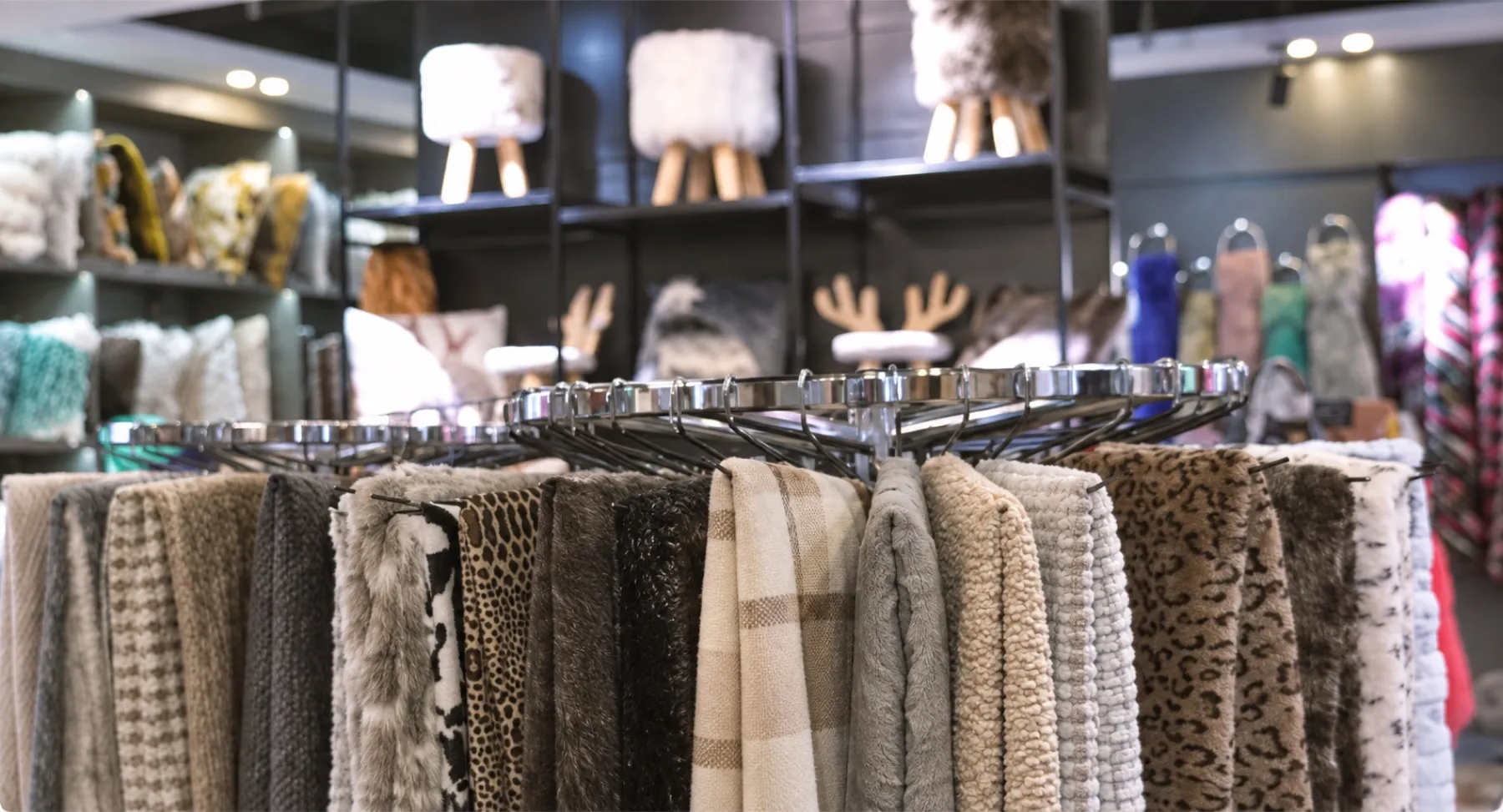 Faux fur throw samples on a sample-room rack — prints, stripes and plaids